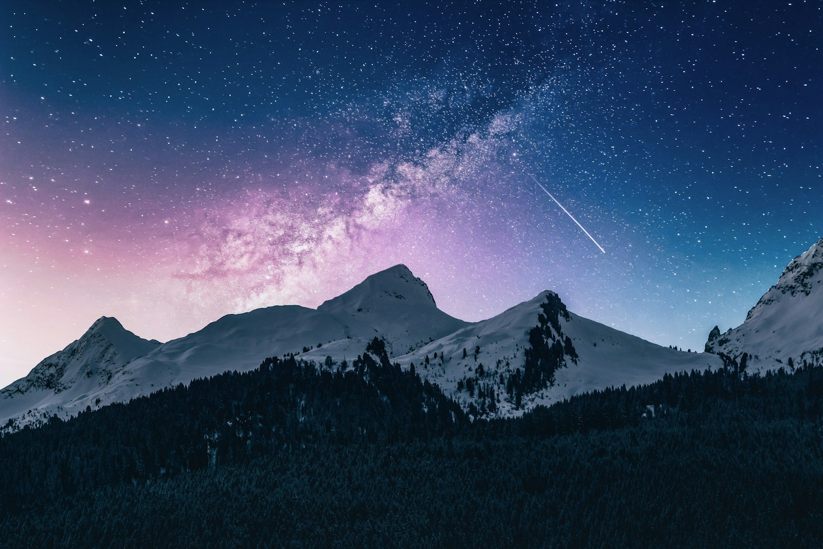 A dark mountain landscape under a cloudy night sky